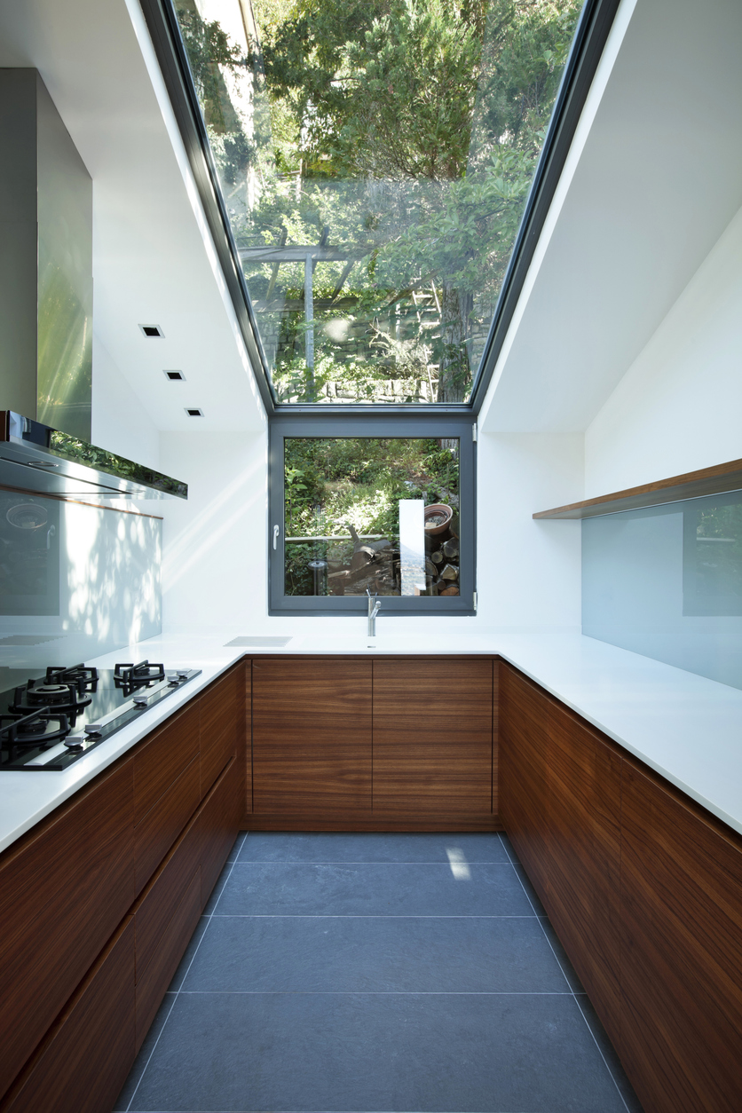 Modern open-plan kitchen extension with bi-fold doors opening to garden