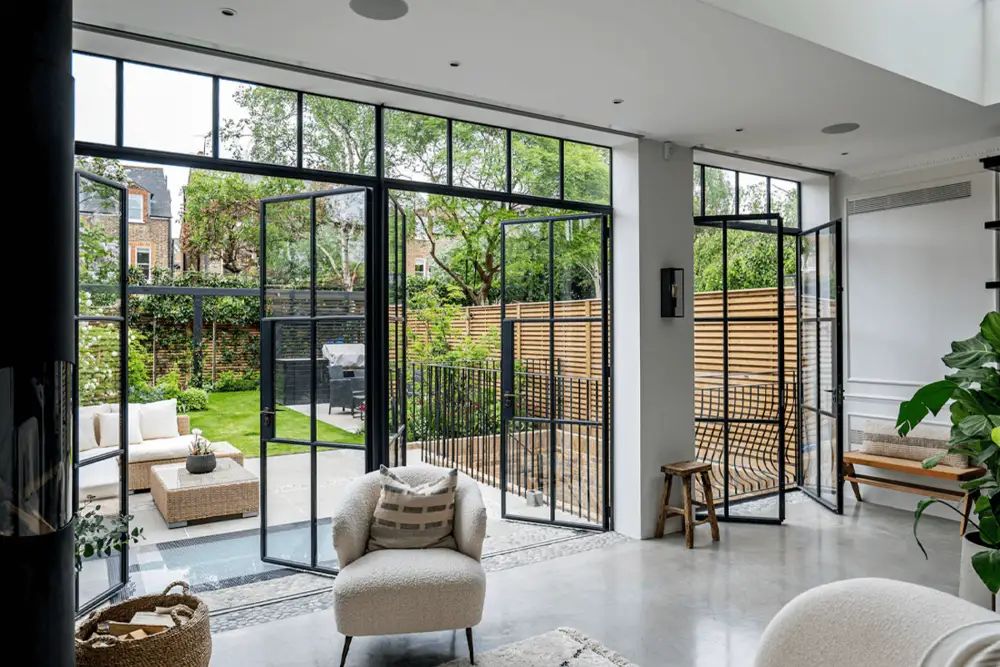 Crittall-style glazed extension with steel-framed doors and natural light — Hampshire Build