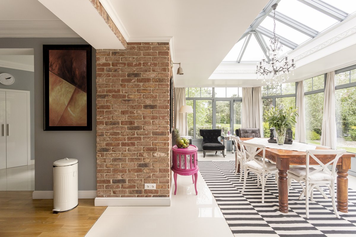 Rear extension dining area with exposed brick pier and glazed orangery beyond — Hampshire Build